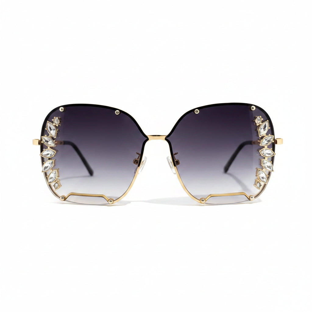 Oversized square sunglasses with gradient dark lenses, gold metal frames, and crystal embellishments along the outer edges, shown on a plain white background.