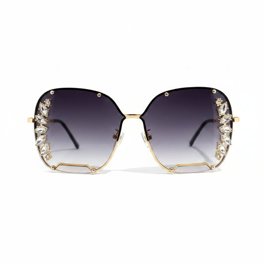 Oversized square sunglasses with gradient dark lenses, gold metal frames, and crystal embellishments along the outer edges, shown on a plain white background.