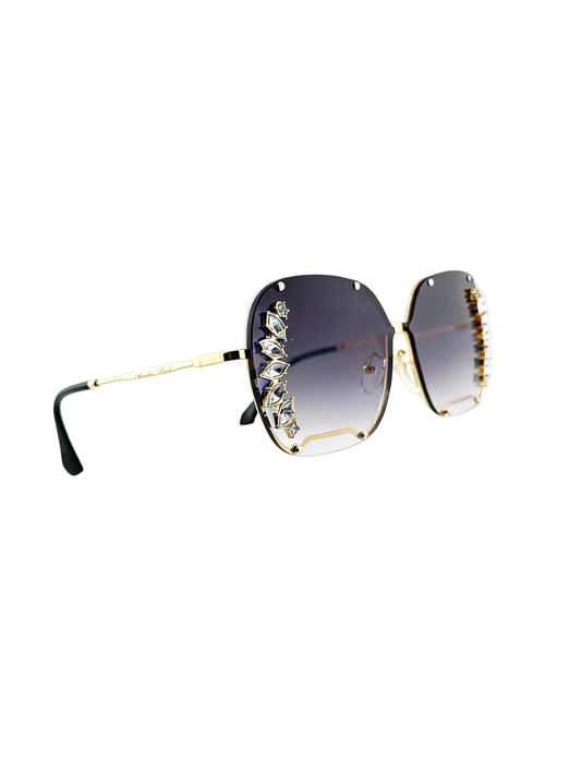 Oversized square sunglasses with dark gradient lenses, gold metal frames, and crystal embellishments on the outer edges, shown on a white background.